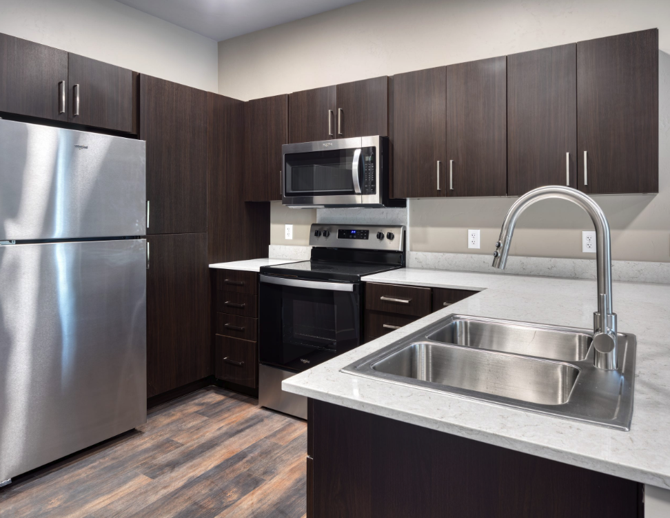 Sagebrush Apartments in WY, Jacksonville. kitchen with white countertops and espresso cabinets